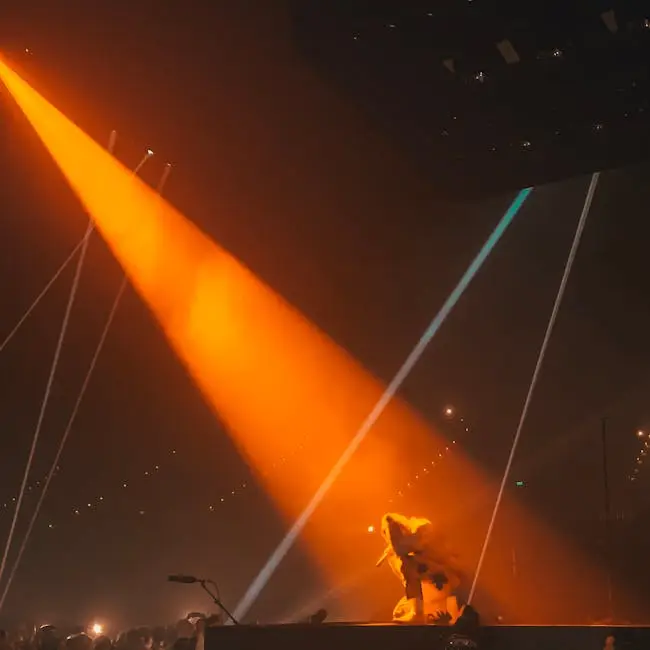 Artist on stage with vibrant orange lights during a live concert in Hindmarsh, Australia.