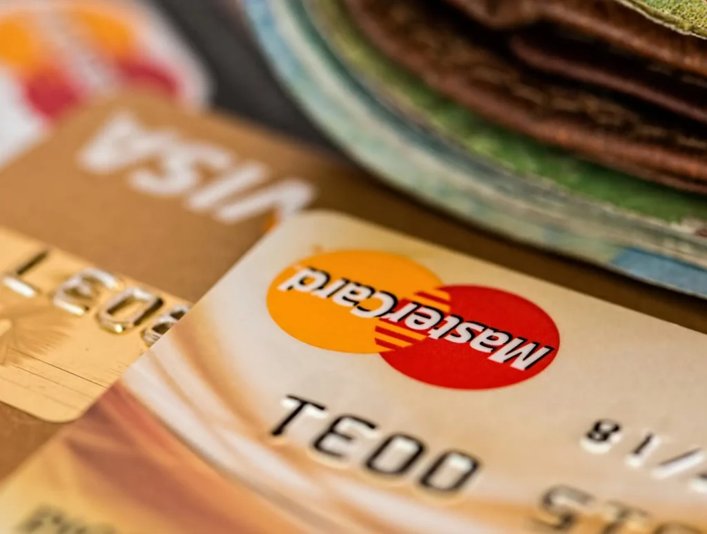 Macro shot of credit cards showing Visa and Mastercard logos next to a wallet, ideal for finance themes.