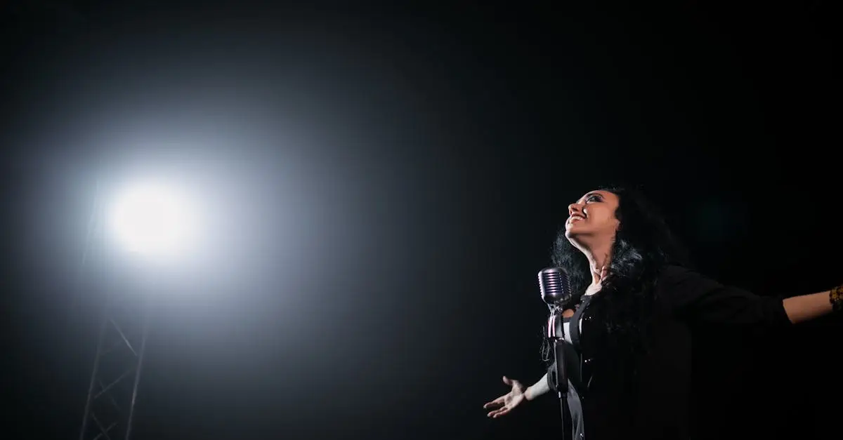 A passionate female singer performs on stage under a dramatic spotlight.