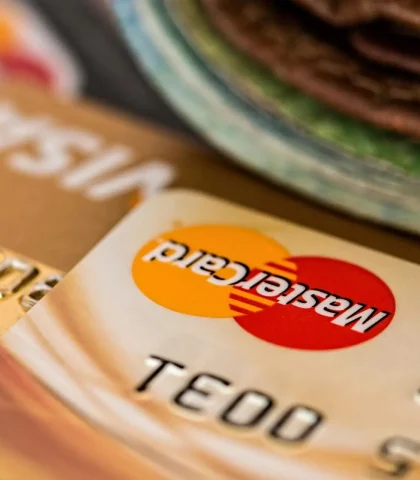 Macro shot of credit cards showing Visa and Mastercard logos next to a wallet, ideal for finance themes.